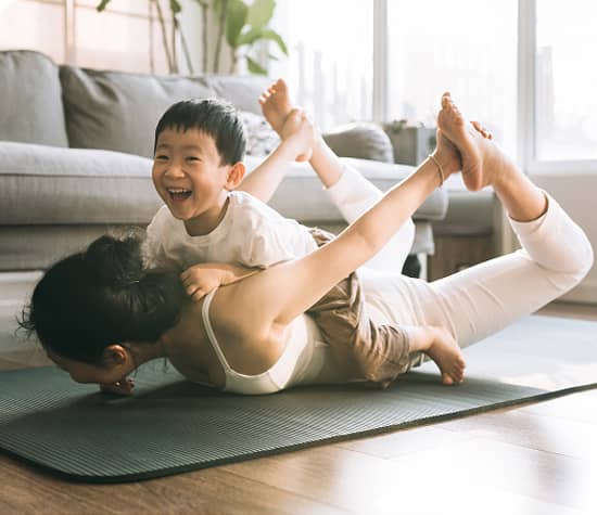 Person looking off to the side as the wind blows, and the sunsets in the background