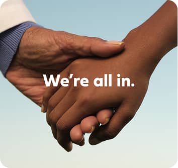 Image of two holding hands with the text We're all in.