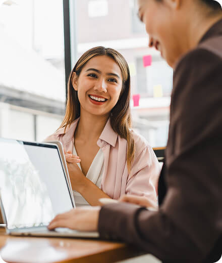 Two people working and talking in an office setting