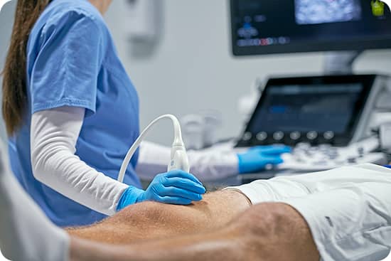 Image of an ultrasound being done on a patient's lower thigh