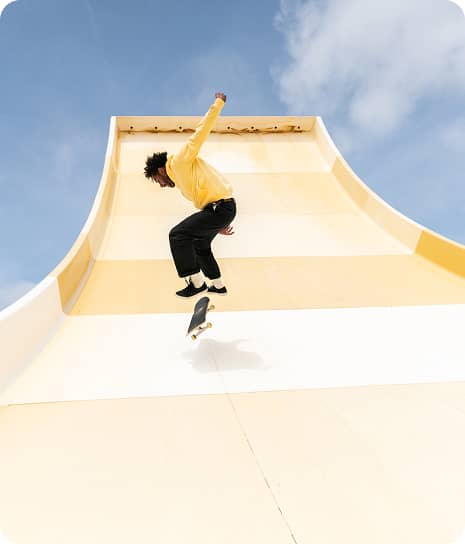 Person doing a skateboard trick on a pipe