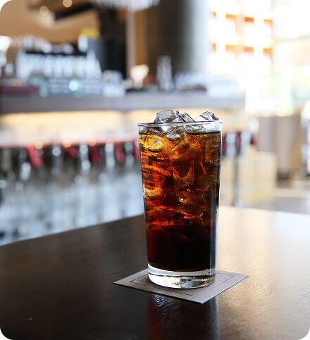 Glass of dark soda in a bar