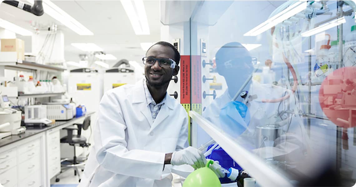 Person in a lab performing a test and smiling