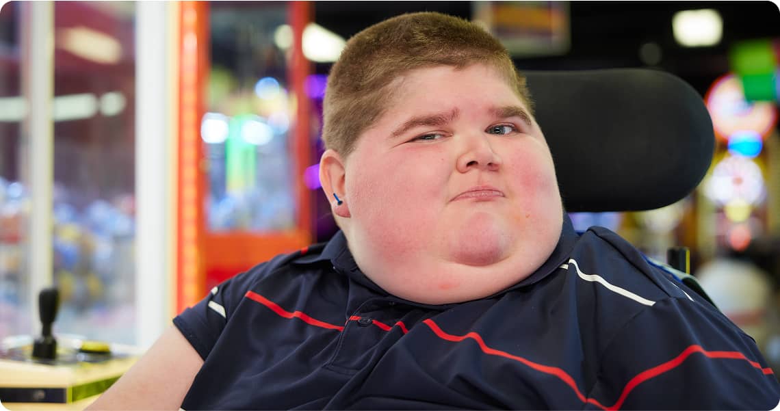 Child in a wheelchair looking at the camera